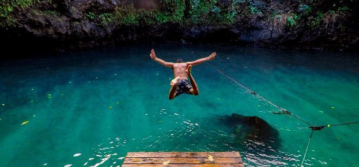 Man jumping headfirst into tropical lagoon