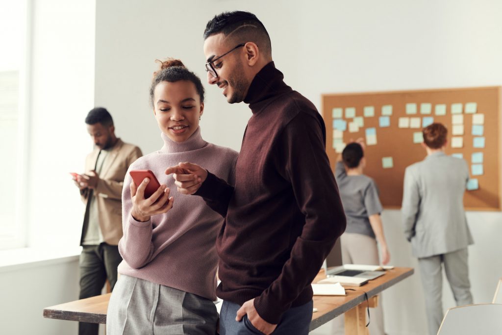 two people looking at a phone