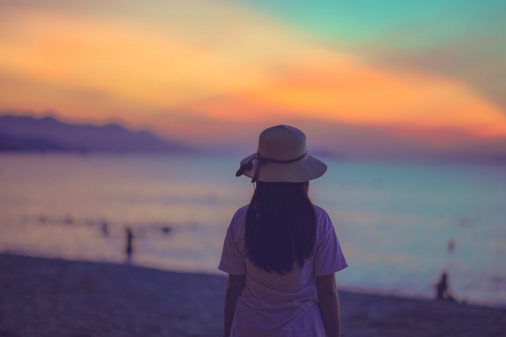 Woman on beach at sunset