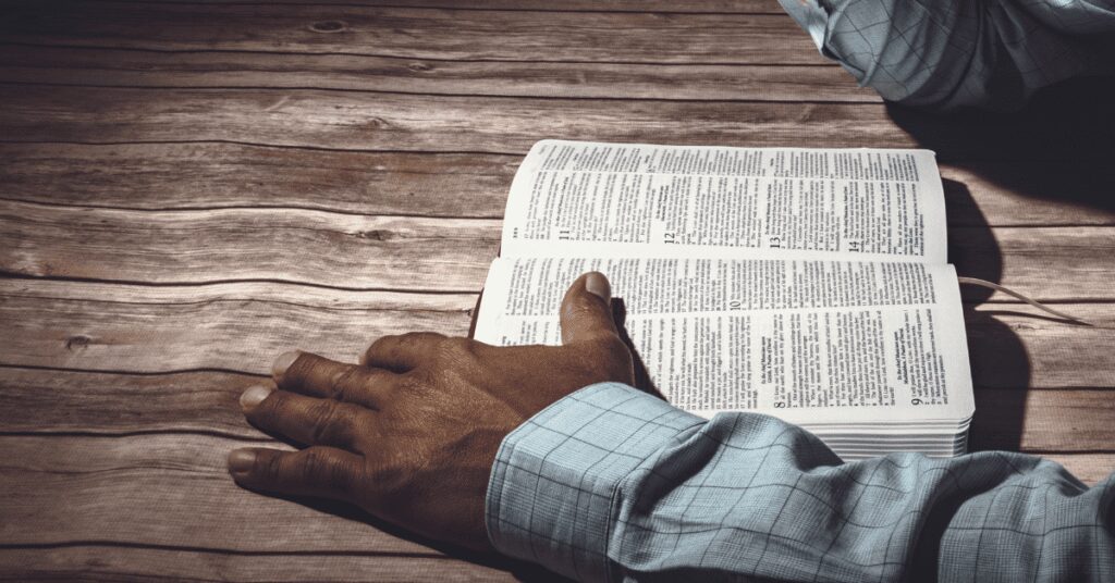 bible and hand