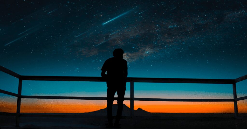 person and shooting stars