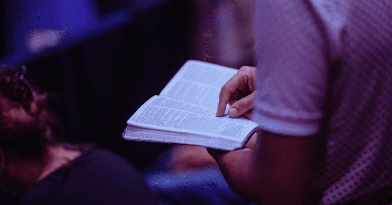 Header image that shows a man holding an open Bible.