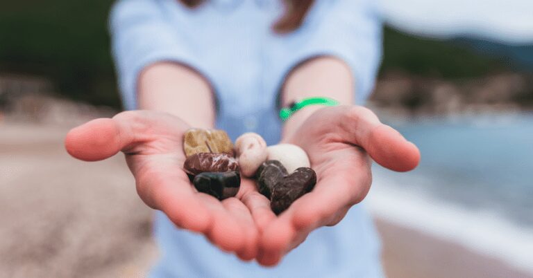 Outstretched hands holding rocks.