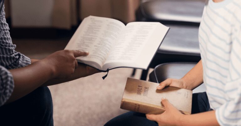 Closeup of hands with Bibles.