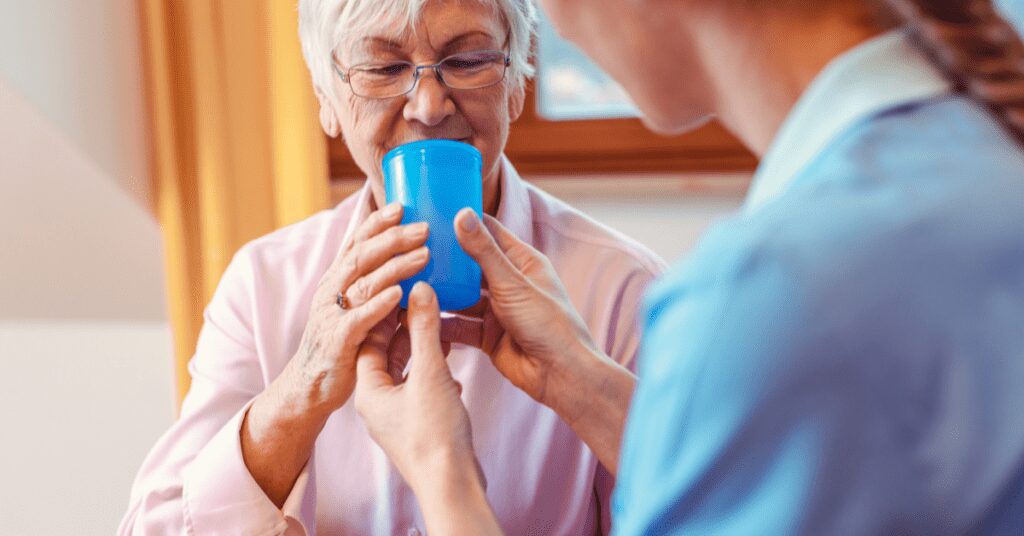 Woman given a drink of water.