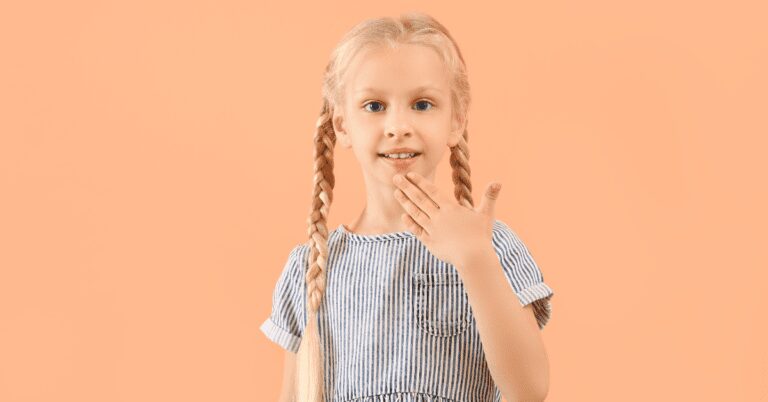 Child doing ASL thank you sign.