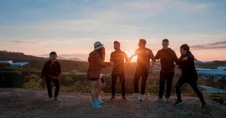 Teenagers in a desert at sunset.