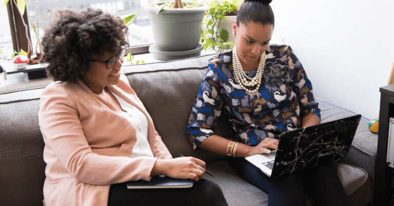 Women on a couch talking.