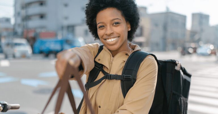 A woman holds out a bag.