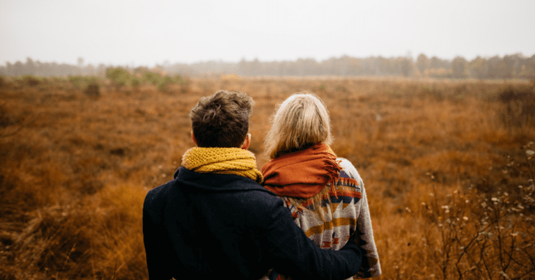 Couple staring out at a landscape.