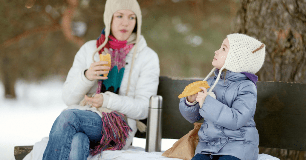 mother and daughter talking outside on a winter day