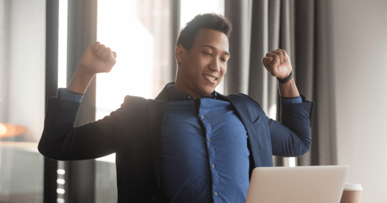 man stretching while working at his computer