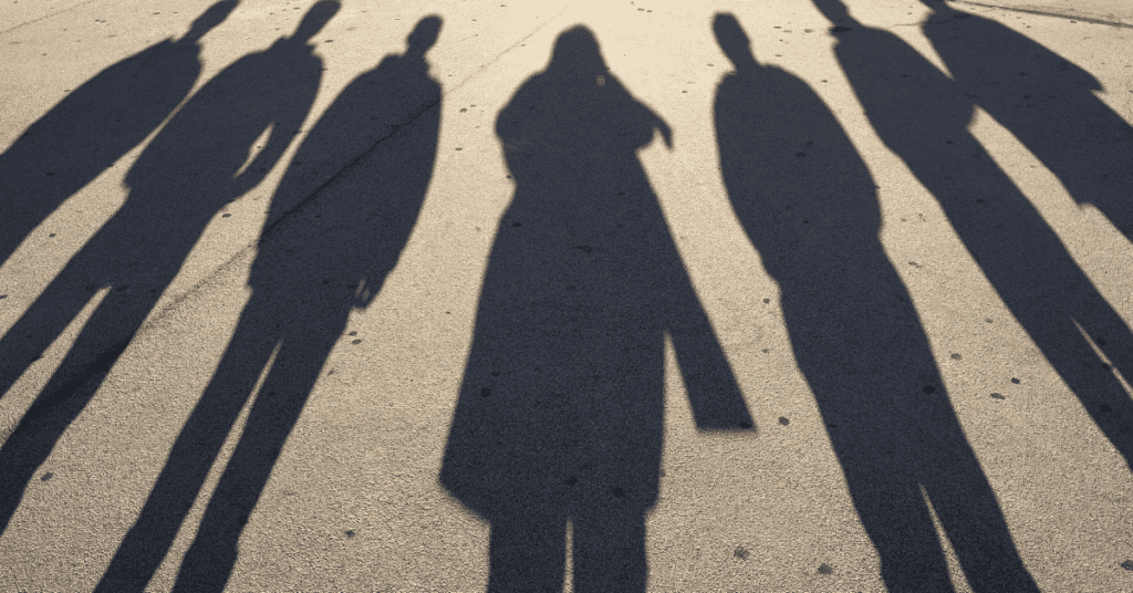 long, ominous shadows of people on concrete