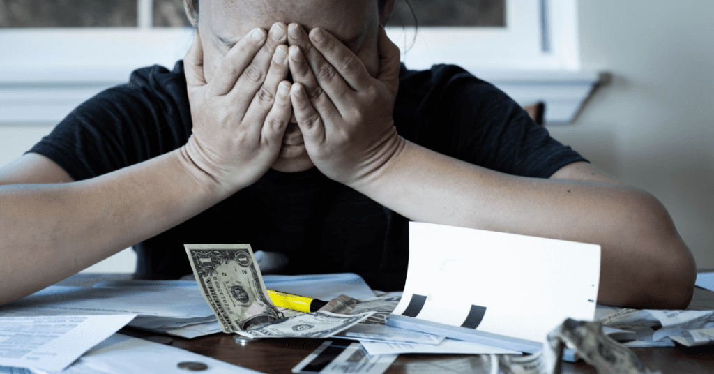 person in anguish looking over their bills