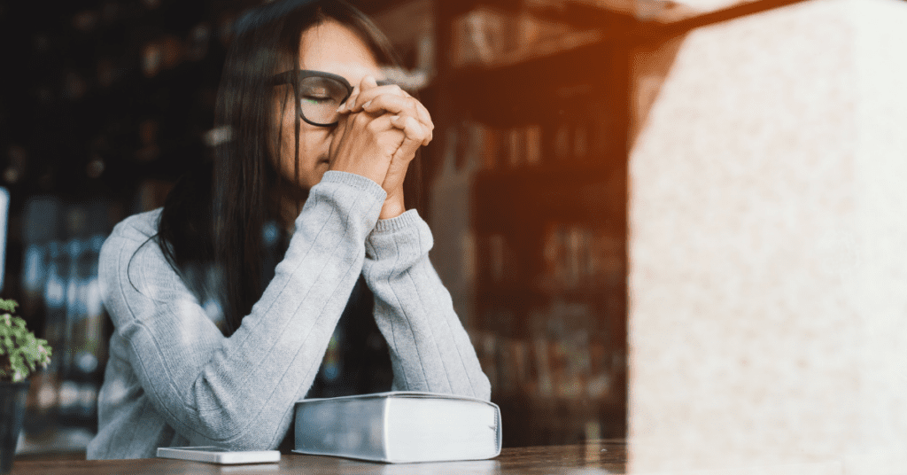 woman praying in library
