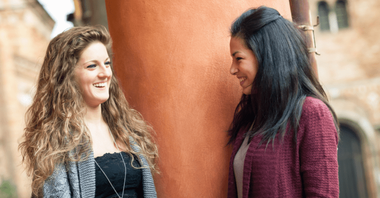 women talking and smiling