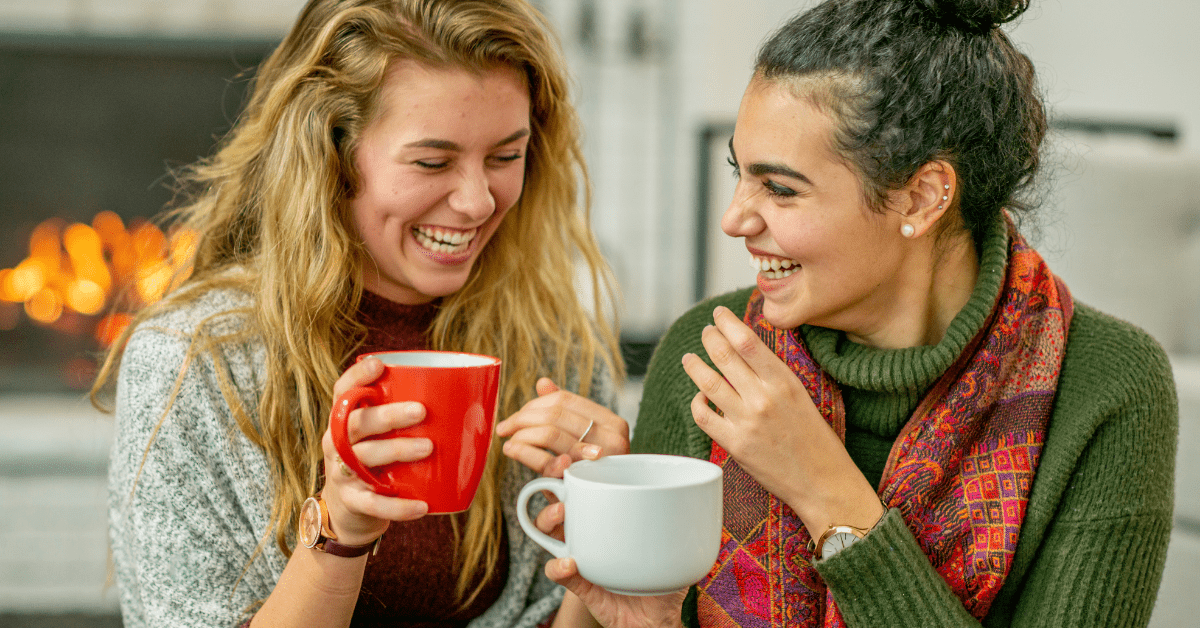 Two women laughing with coffee