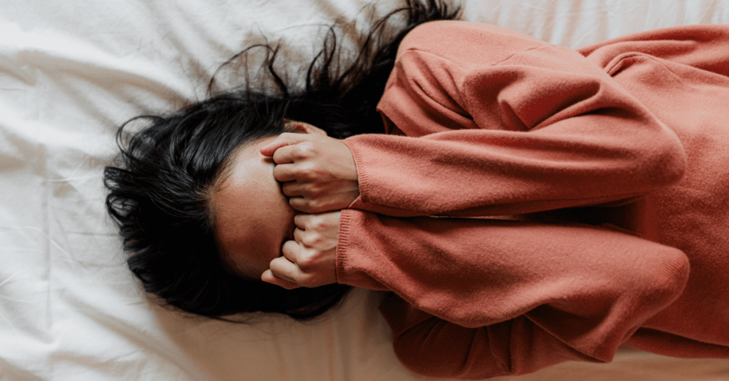 woman covering her face with her hands