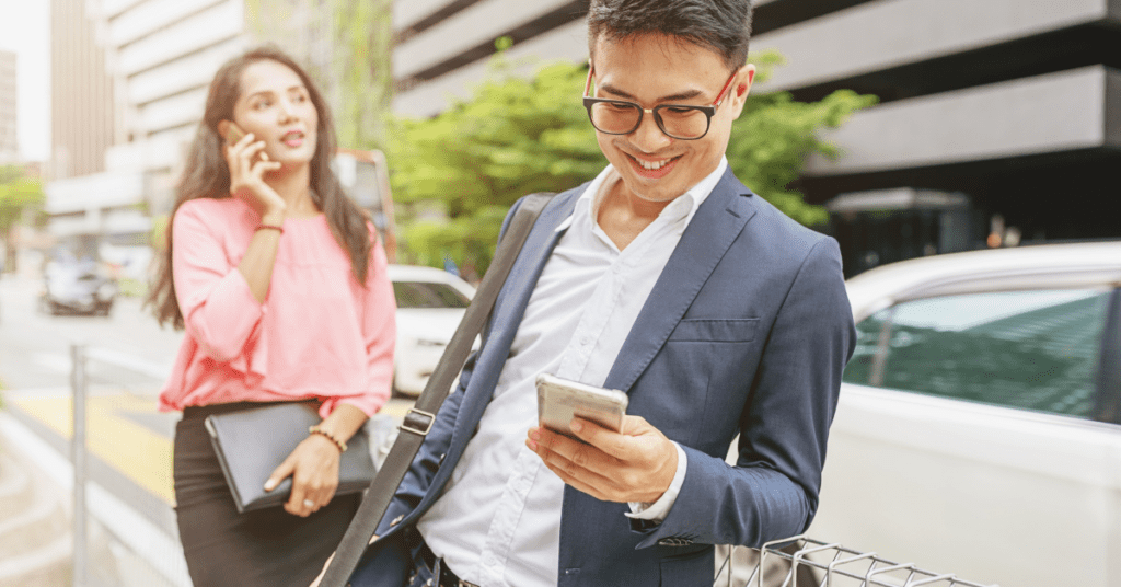 man and woman in business clothes on their phones