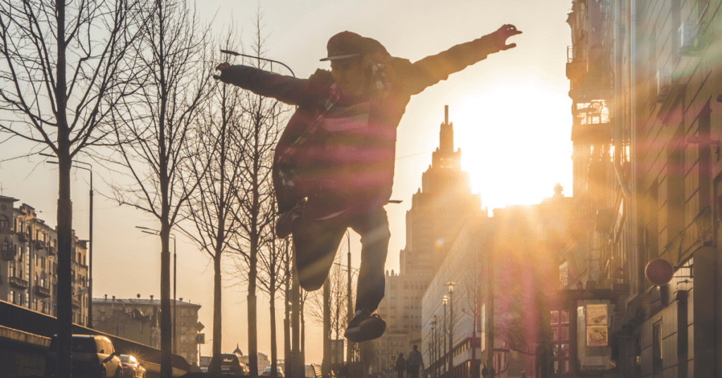 Man jumping in the air city sunset.