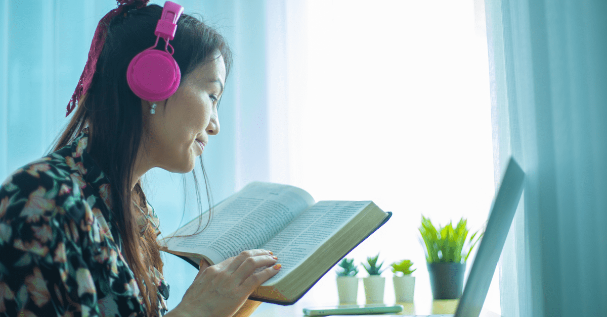 women with headphones listening and following along to an online lesson