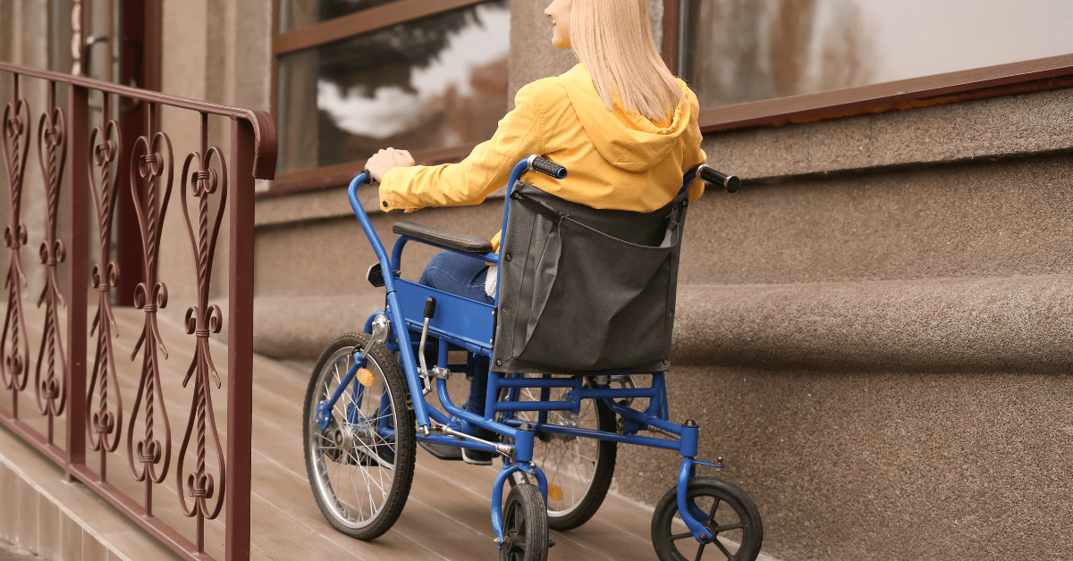 woman wheeling her wheel chair up a ramp