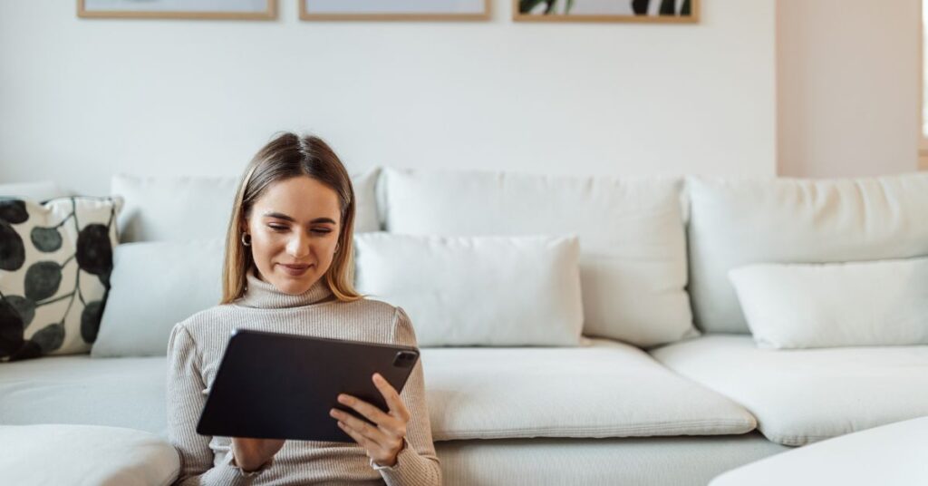 woman reading on her tablet on the ground