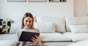 woman reading on her tablet on the ground