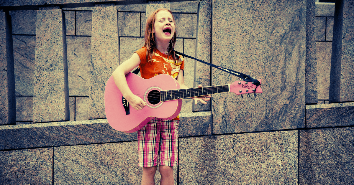 girl playing pink guitar