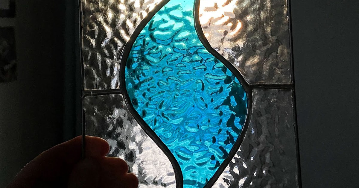 Faith+Lead blue flame logo in stained glass