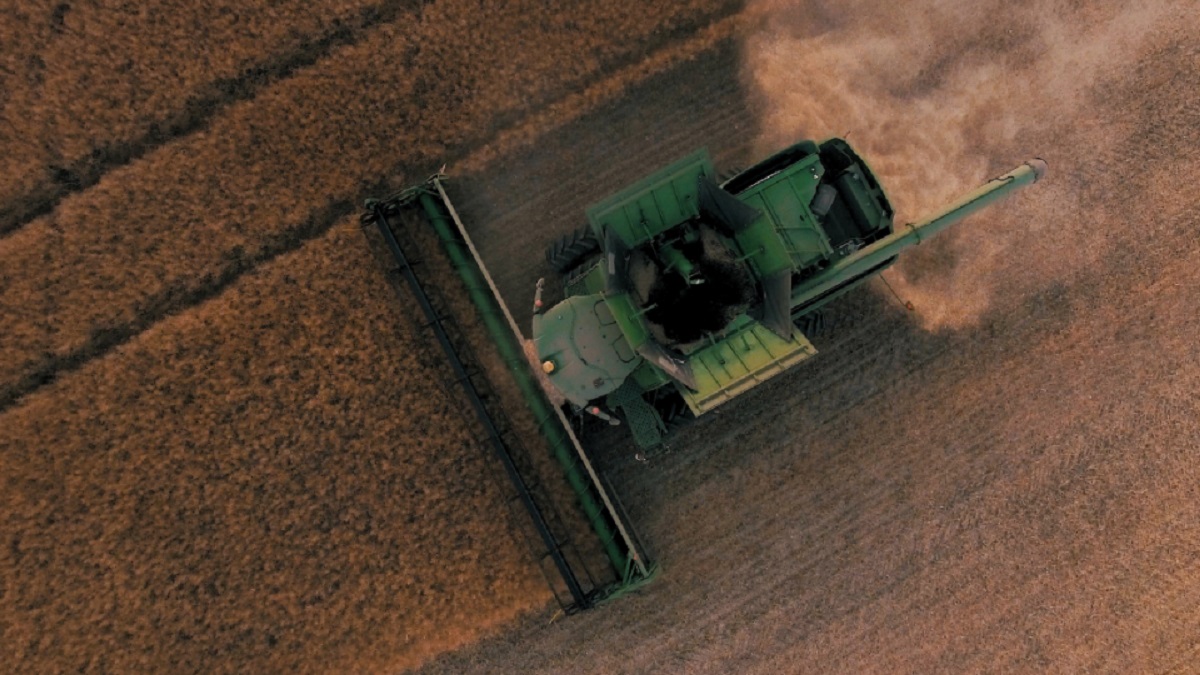 Farm machinery harvesting crops