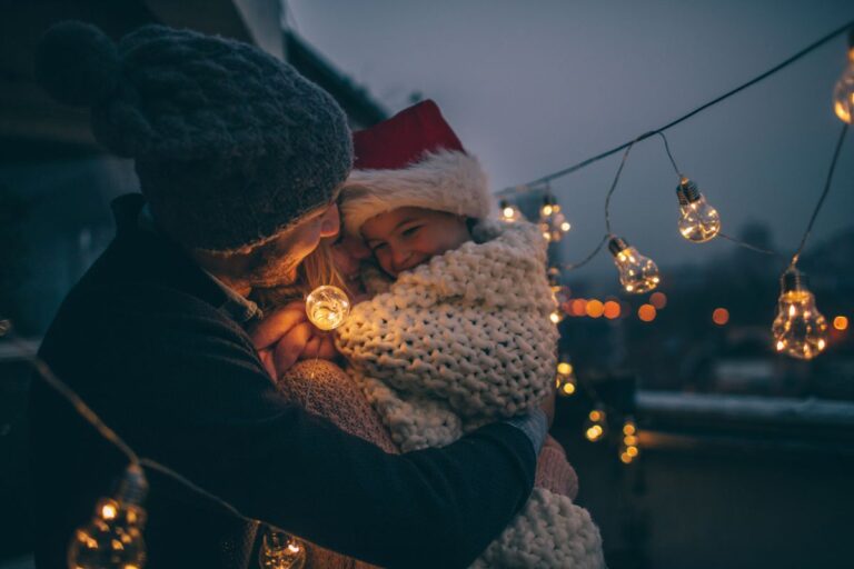 Young, happy, family together at the terrace of their apartment during Christmas holidays