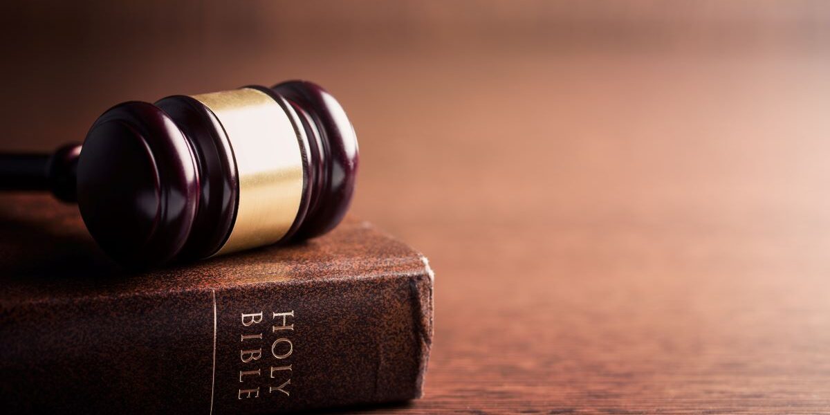 A judge's gavel sets on top of a Holy Bible