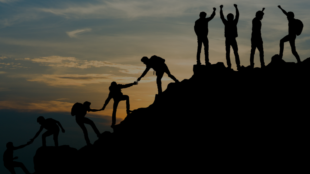Group of people on peak mountain climbing helping team work