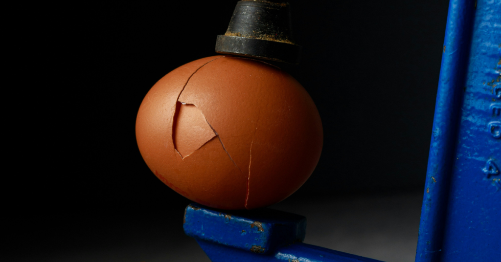photo of an egg cracking under pressure