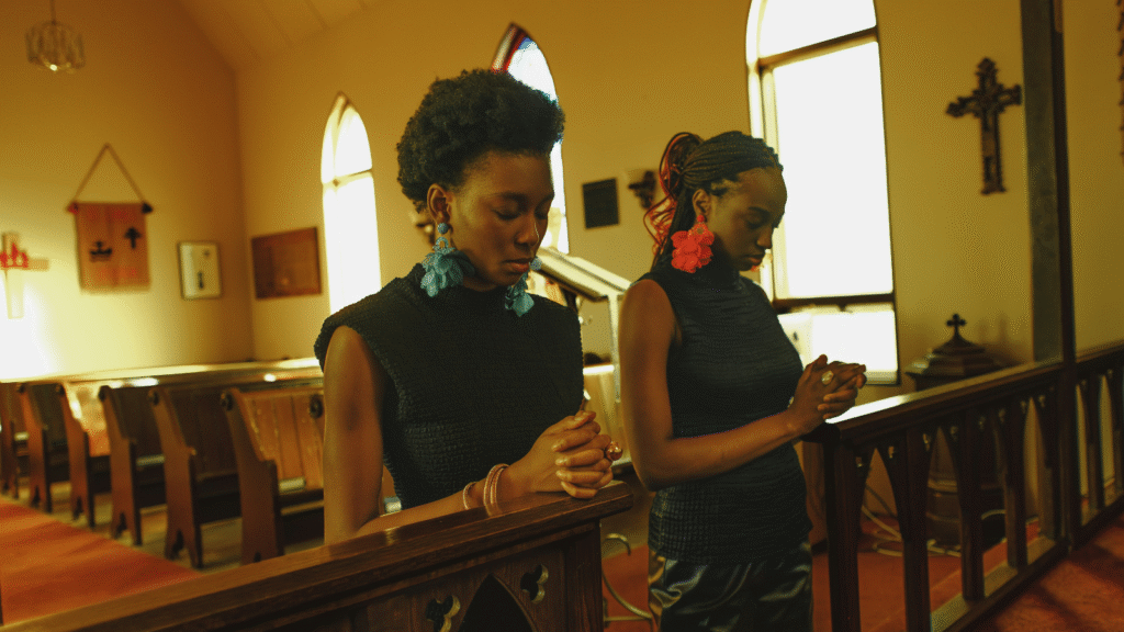 photo of two women praying in a church
