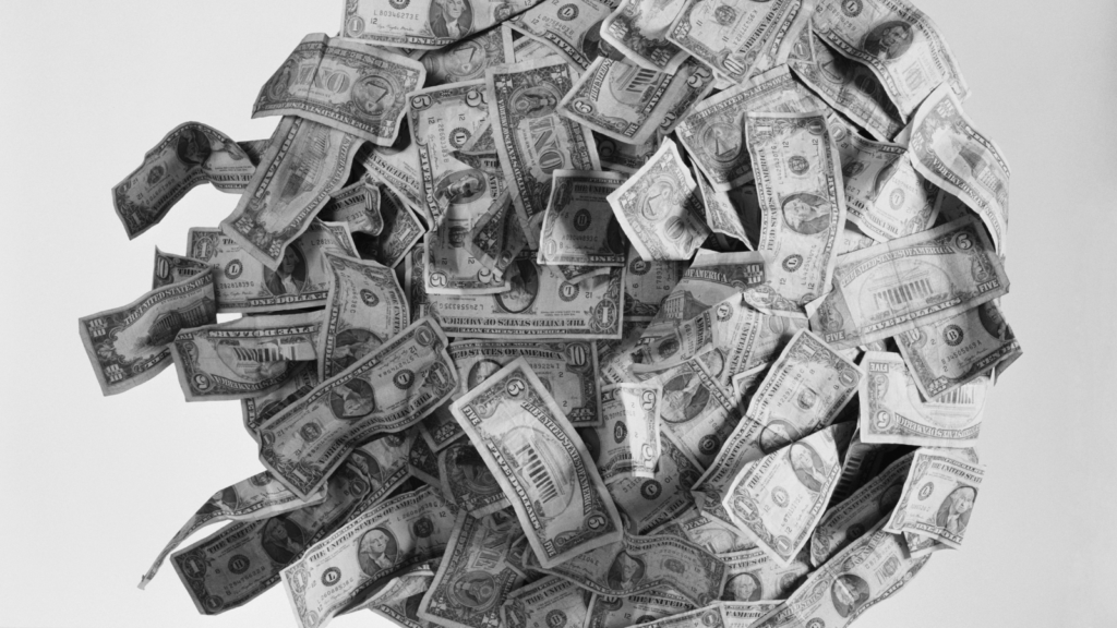 black and white photo of paper money in a ball/tumbleweed shape