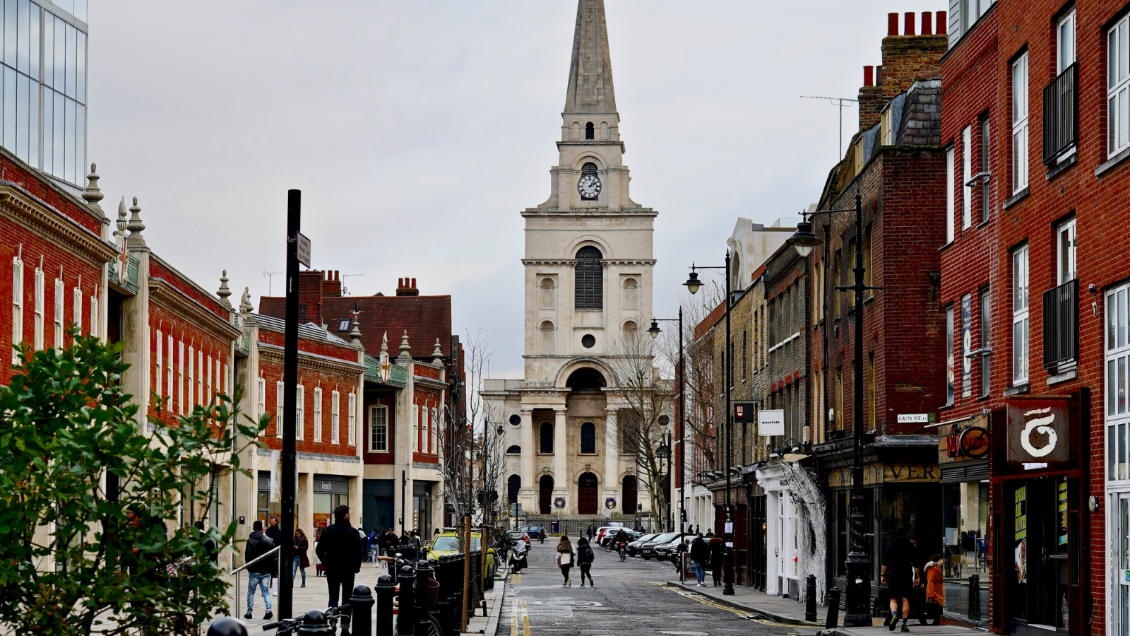 photo of a street in england with a church