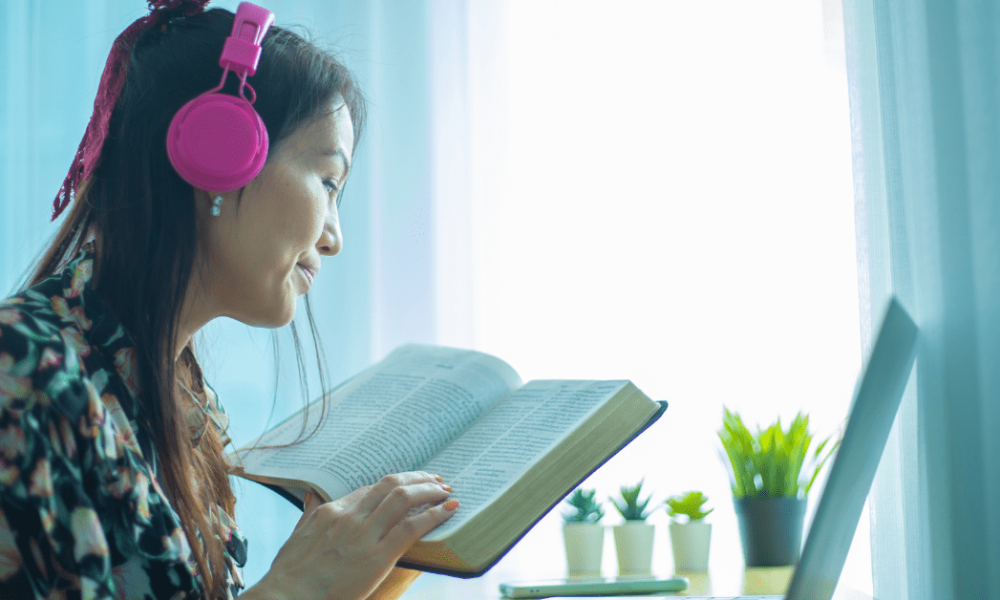 women with headphones listening and following along to an online lesson