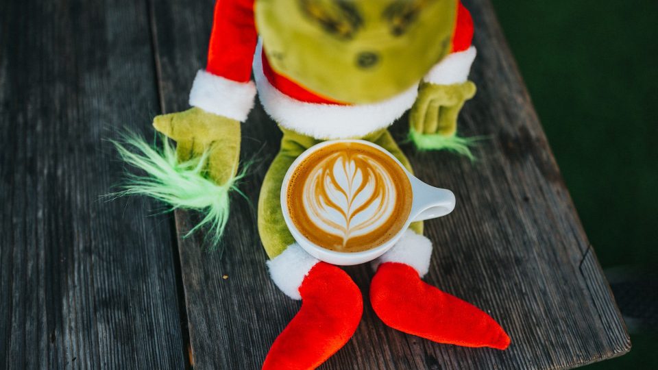 plush grinch with a latte